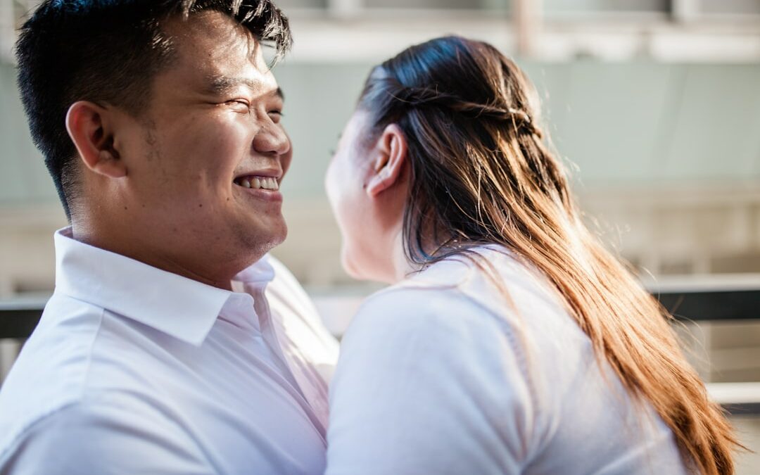 man in white polo shirt kissing woman in white shirt